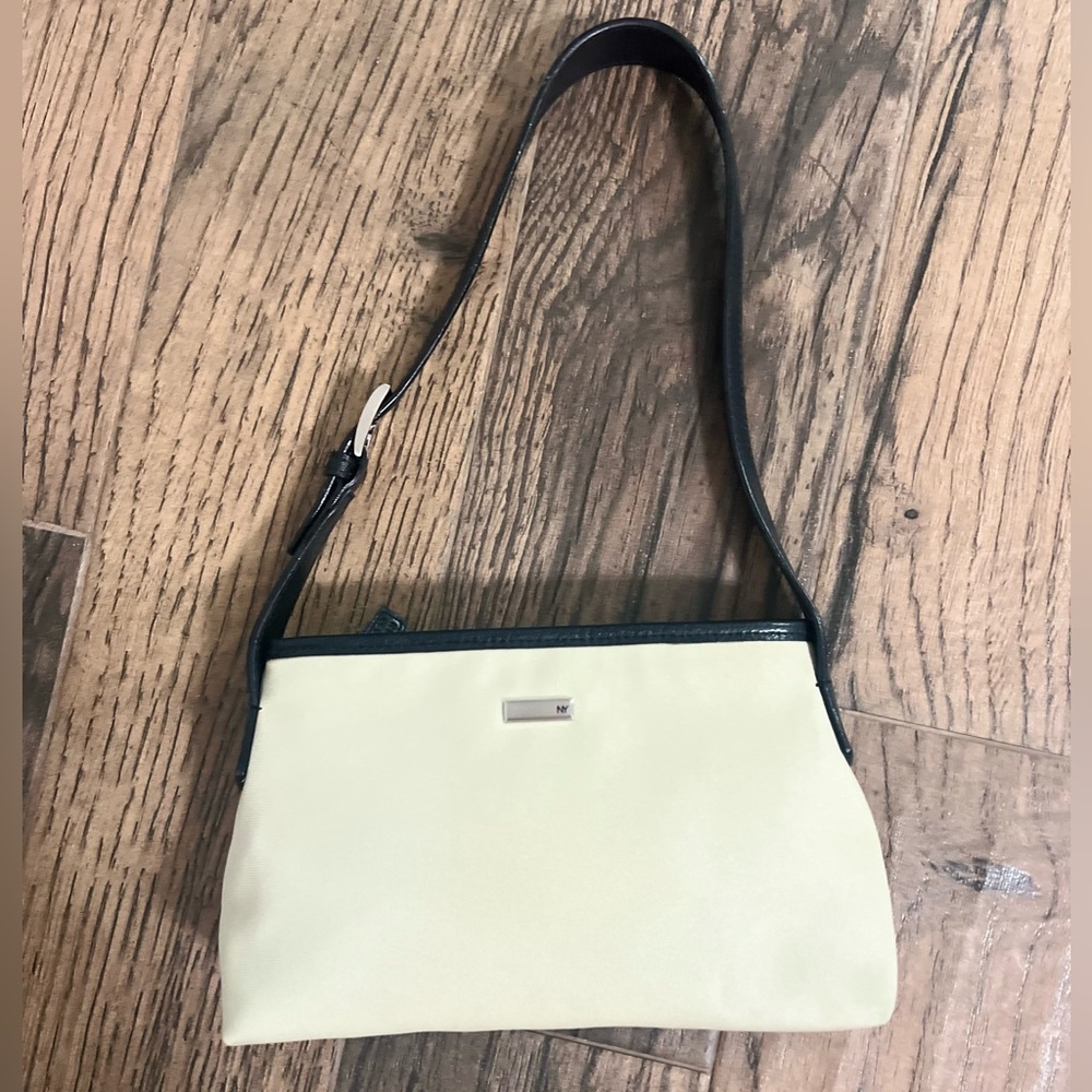 white canvas bag w/ black trim, resembles A.PC. bag on trend for spring